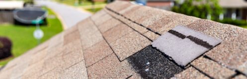 Missing shingles on roof due to storm damage.